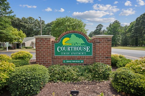 the sign for the courthouse entrance to the court house at the intersection of a road