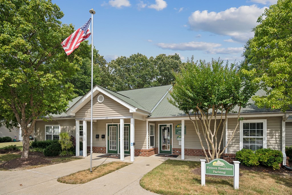 A house with a flag on a pole in front of it.