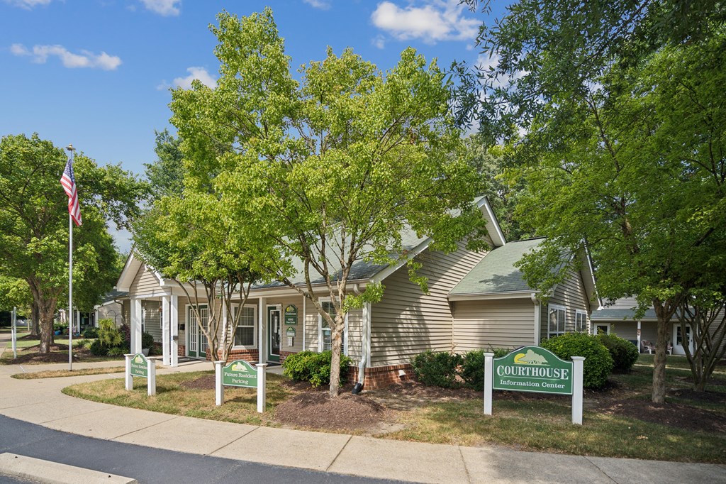 A green sign in front of a house that says