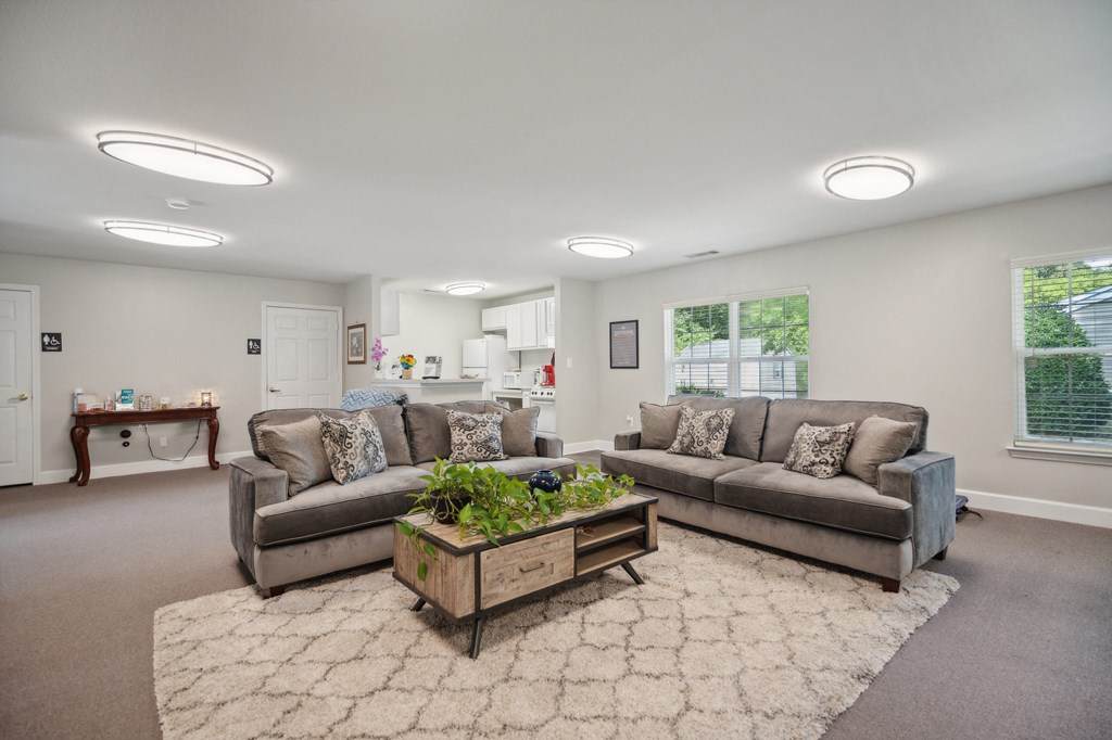 A living room with a grey couch and a wooden coffee table.