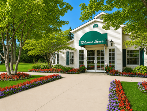 A white building with a green awning that says "Welcome Home".