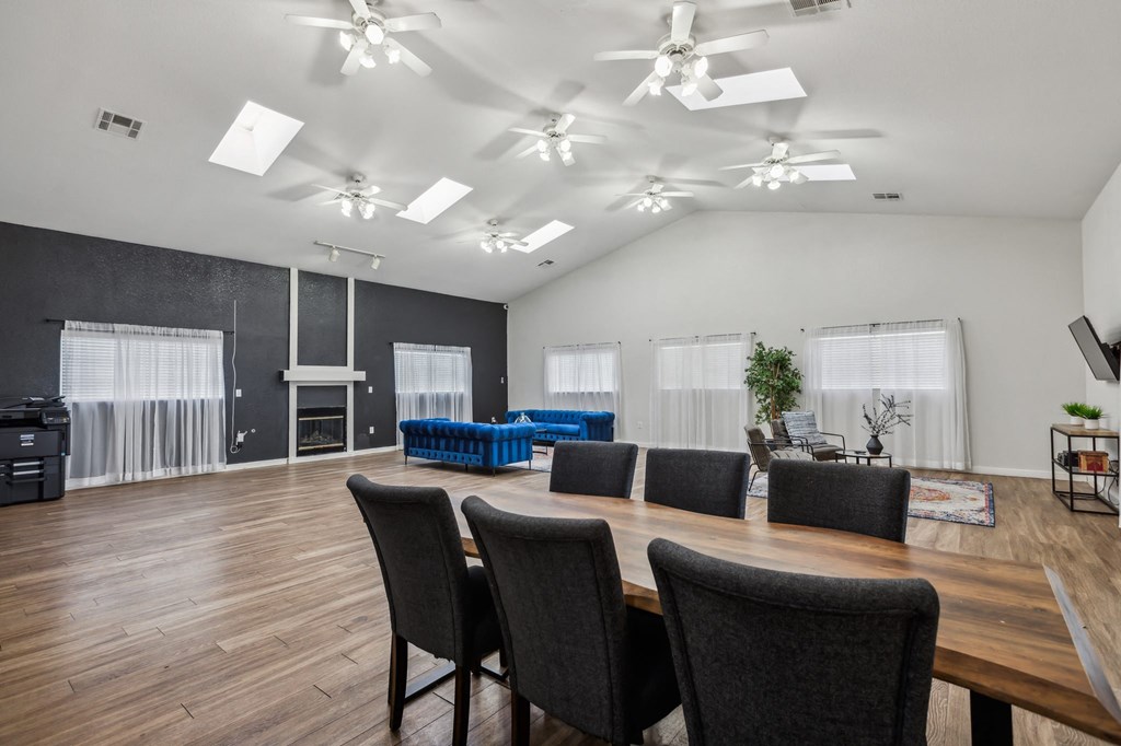 A conference room with a long table and chairs.