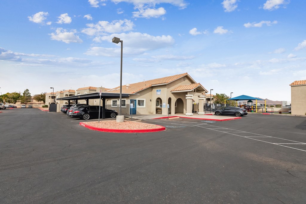 A parking lot with a building in the background.