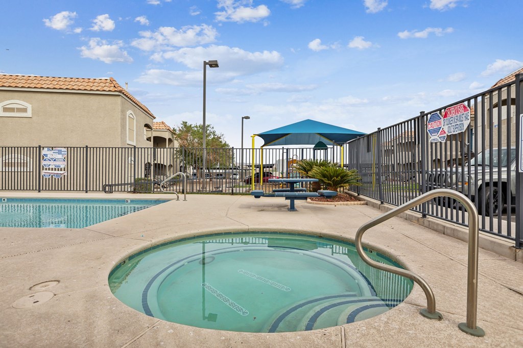 A small pool with a metal fence around it.
