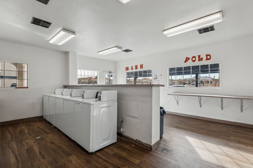 A laundromat with a washer and dryer in it.