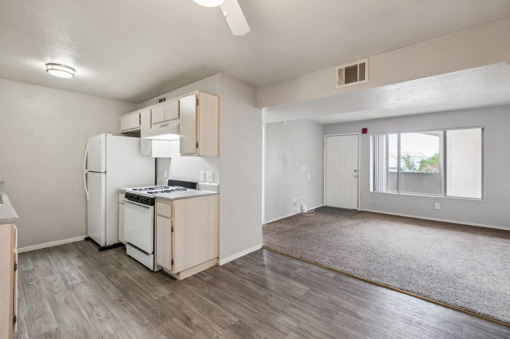 A kitchen with a refrigerator, stove, and oven.