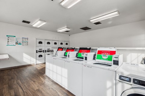 A laundromat with rows of washers and dryers.