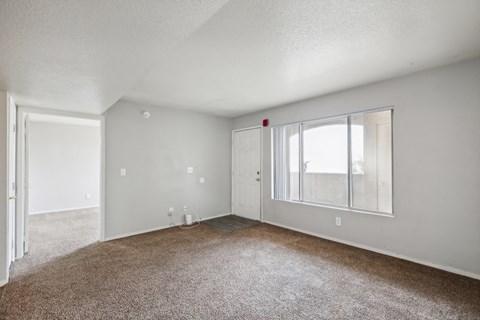 A room with carpeted floor and white walls.