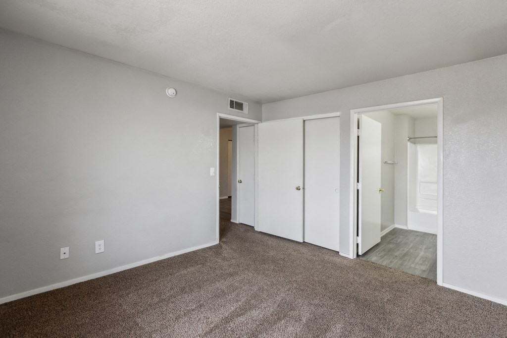 A room with carpeted floor and white walls.