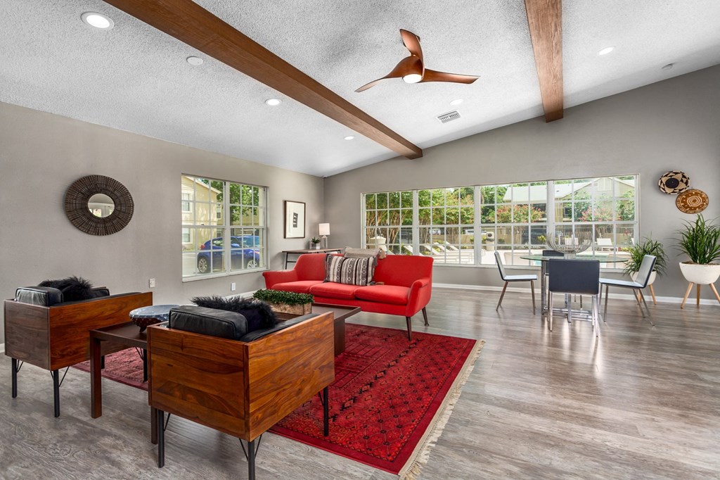 a living room with furniture and a ceiling fan