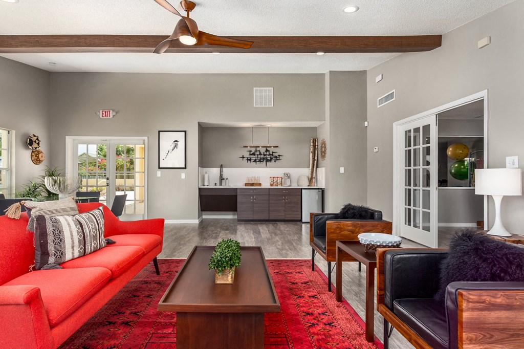 a living room with a red couch and a table