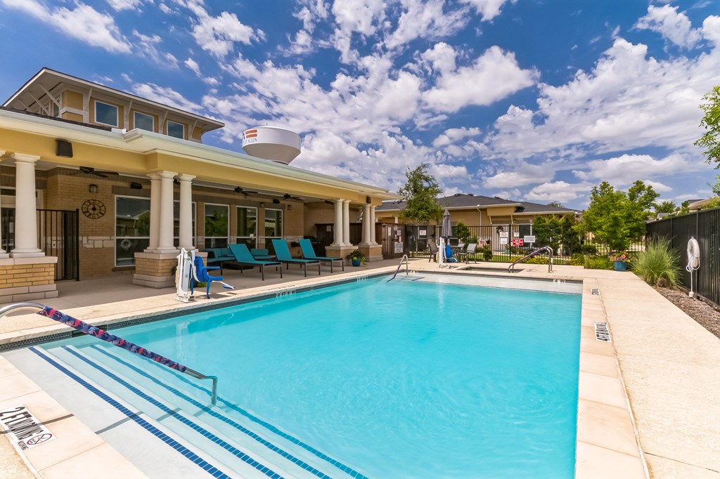 a swimming pool with a house in the background