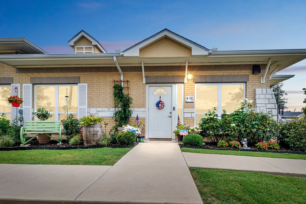 a house with a white door and a sidewalk in front of it
