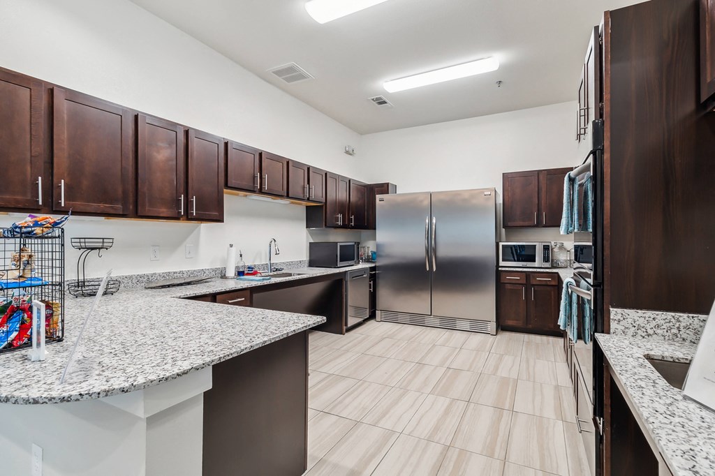full kitchen with stainless steel appliances and granite counter tops at the reserve at south coast