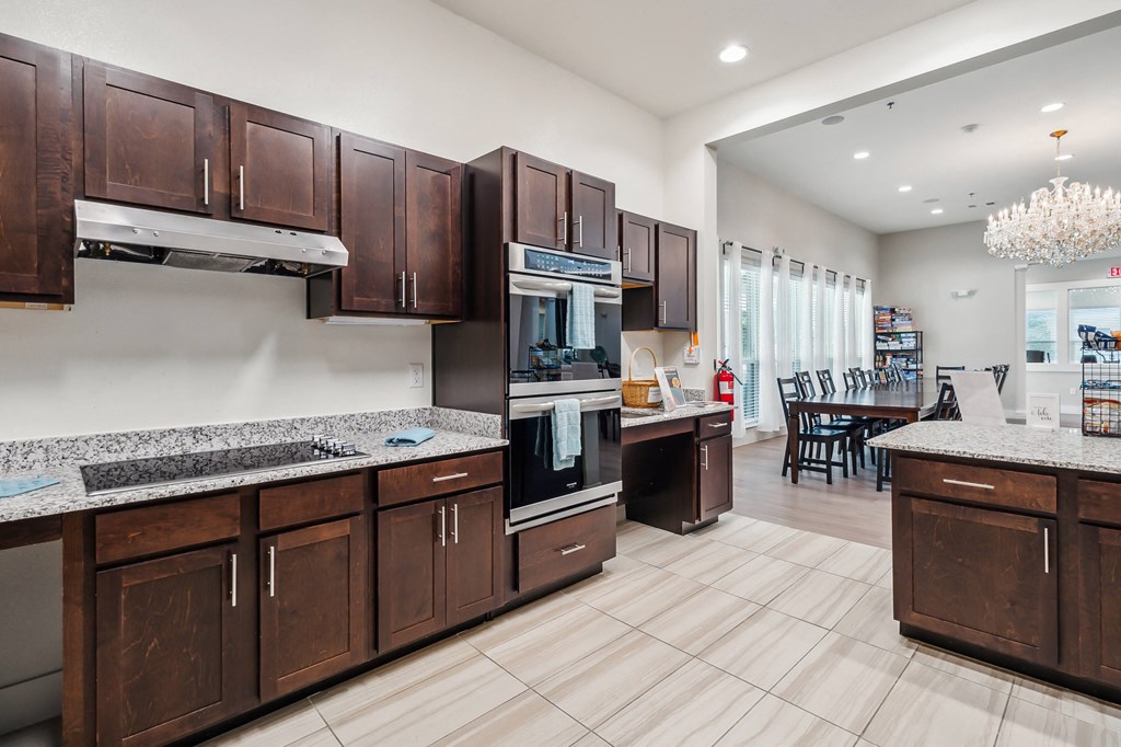 a large kitchen with wooden cabinets and stainless steel appliances