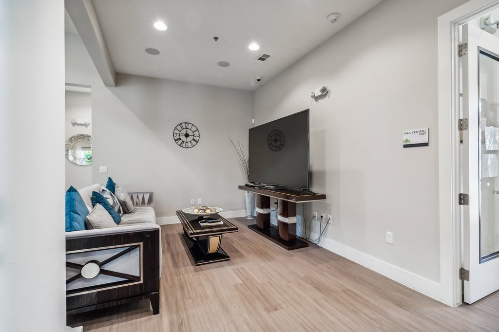 a living room with couches and tables and a television