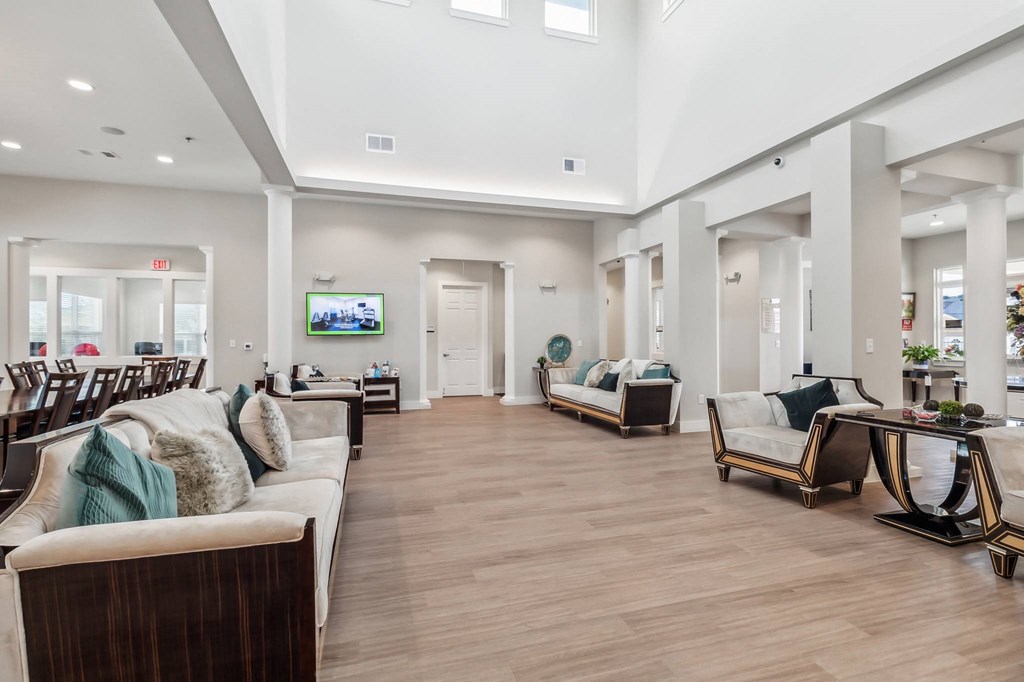 a large living room with couches and chairs