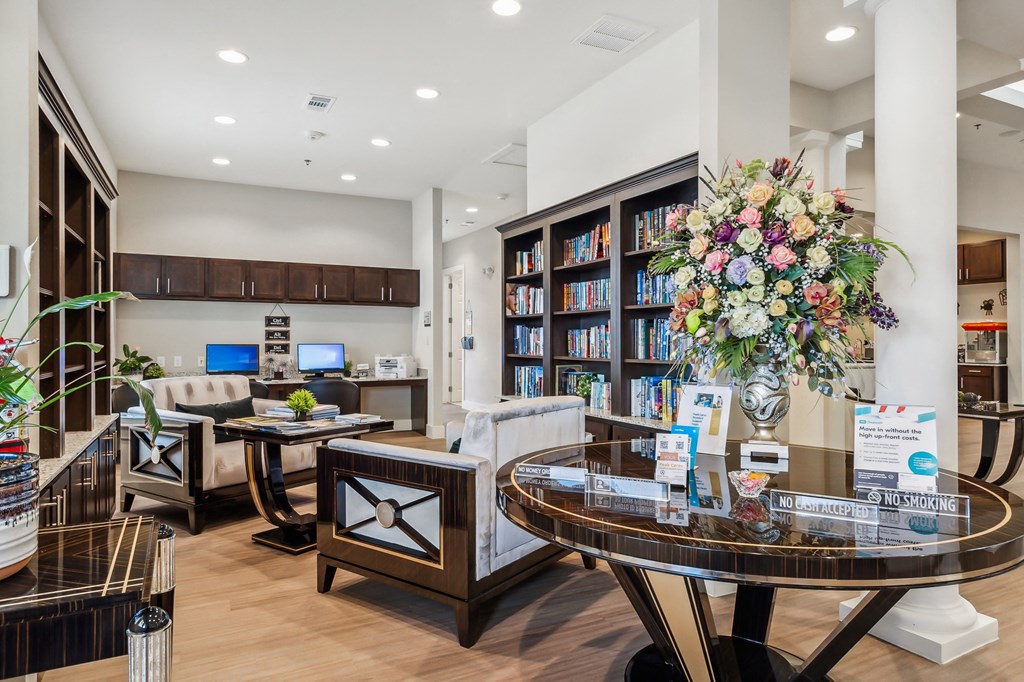 a living room with a table and chairs and a library