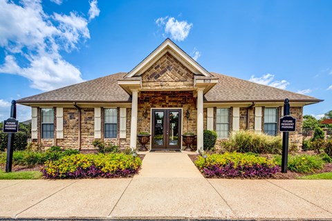 the front of a brick house with a welcoming front door