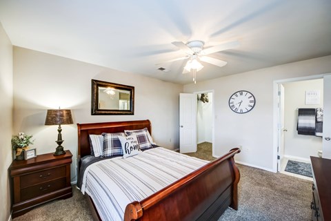 a bedroom with a bed and a ceiling fan