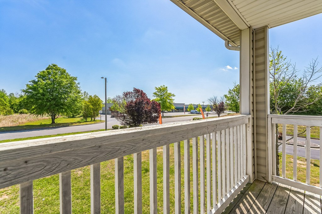 the view from the deck of a home with a wooden railing