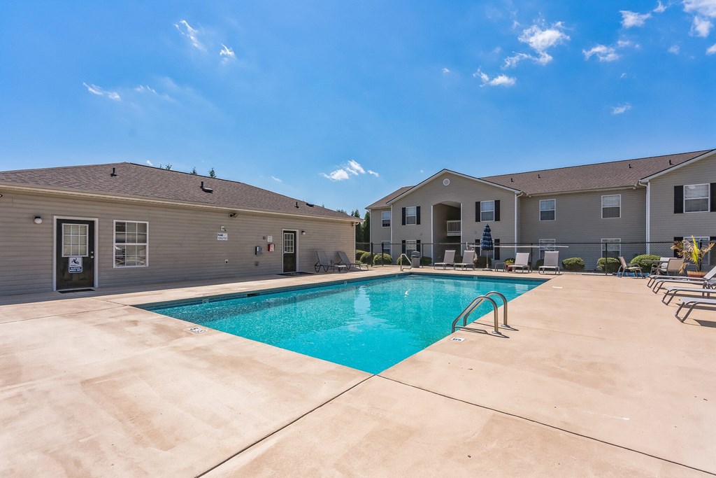 a view of a swimming pool with a blue sky above it