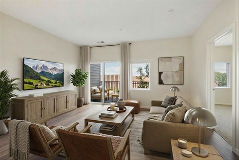 A living room with a large painting on the wall and a flat screen TV mounted above a cabinet.