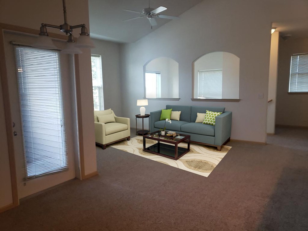 a living room filled with furniture and a large window.