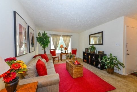 a living room with a red rug and a couch