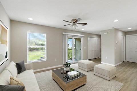 A living room with a white couch and a wooden coffee table.