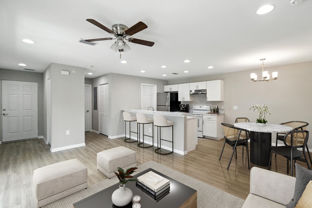 A modern open plan living and kitchen area with a dining table and chairs.