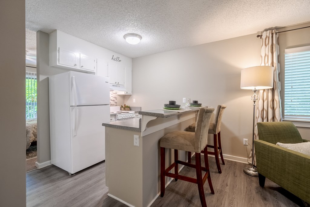 a kitchen with a breakfast bar and a white refrigerator