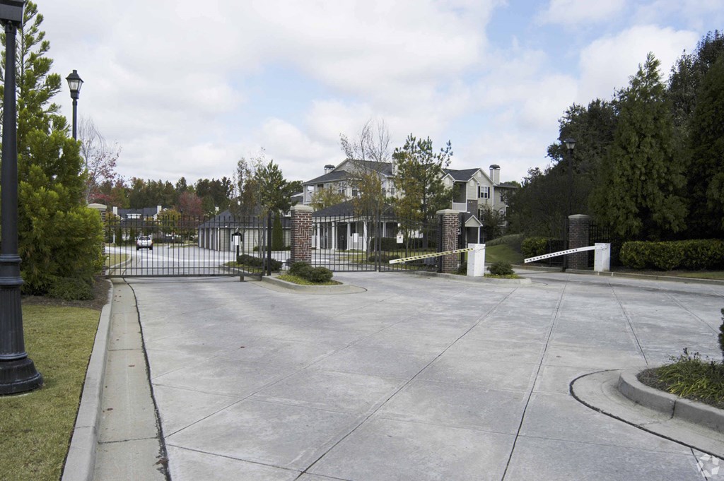 a large driveway in front of a house with a gate