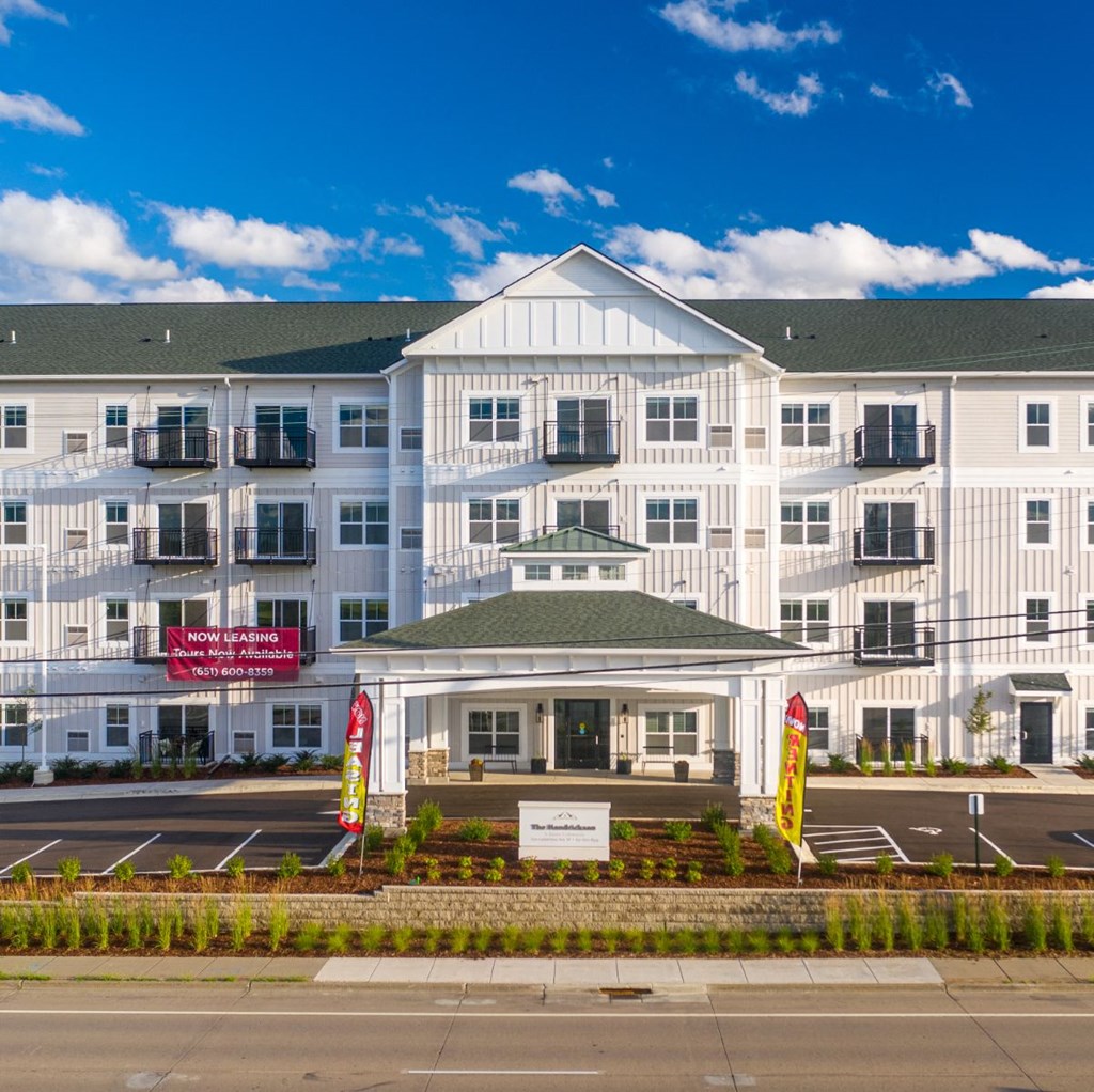 a large building with a sign in front of it on a street