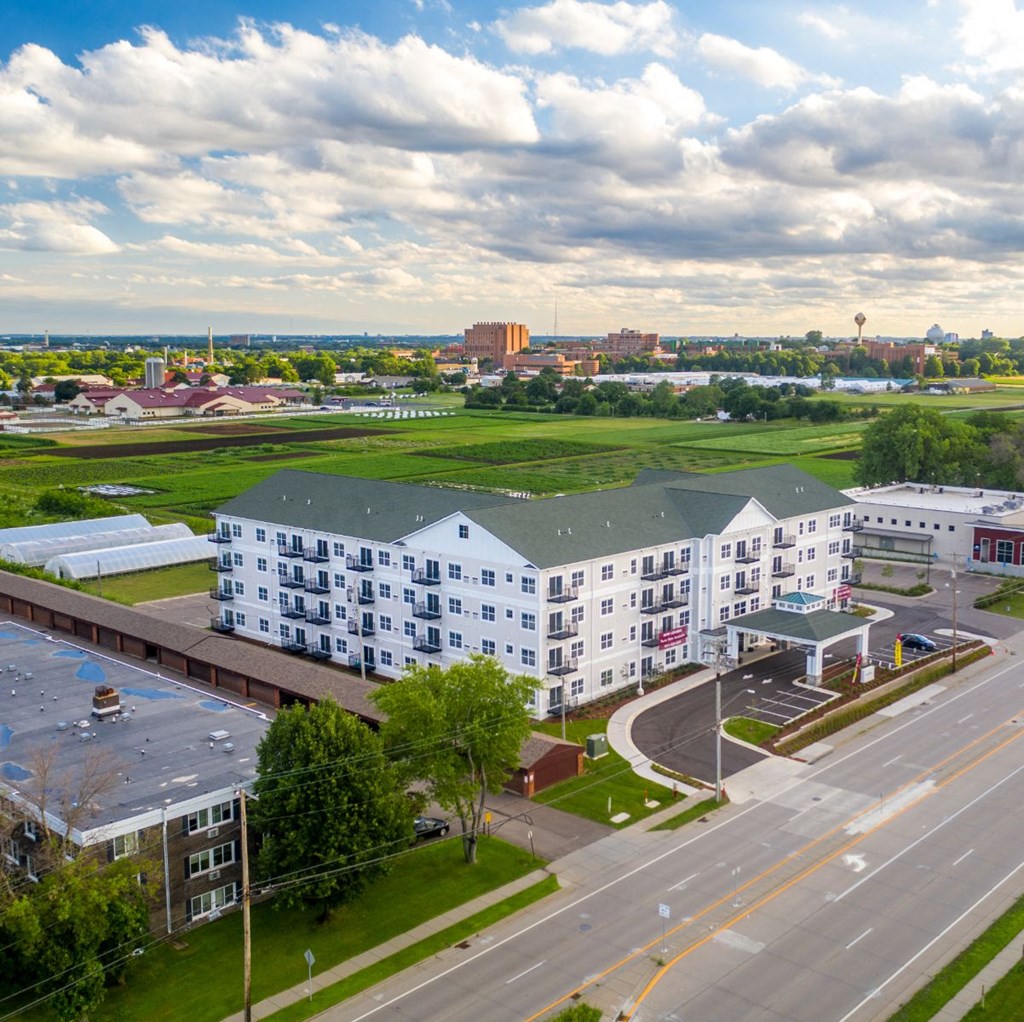 an aerial view of an apartment complex with a city in the background