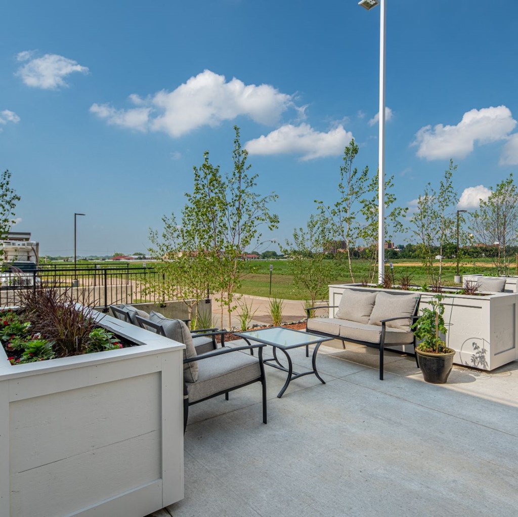 a patio with couches and chairs and a table