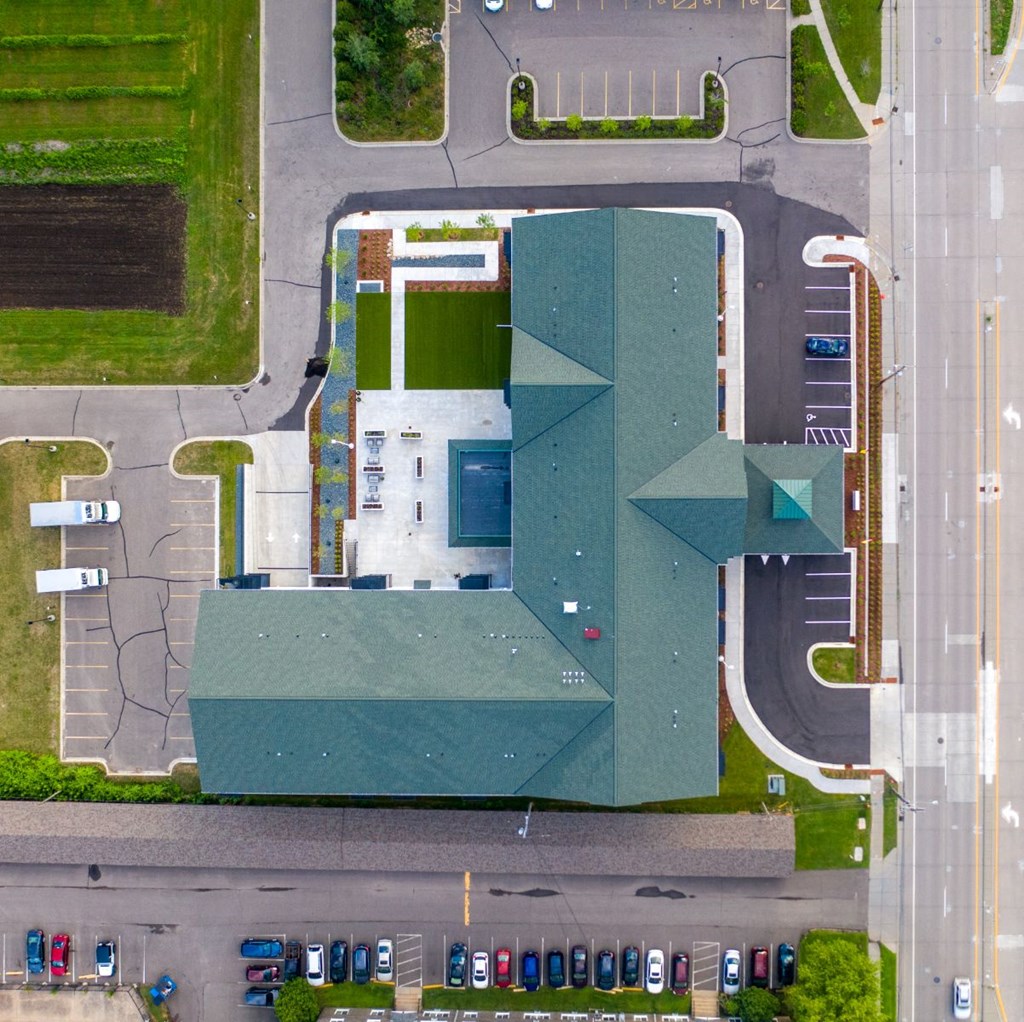 a birds eye view of a building with a parking lot