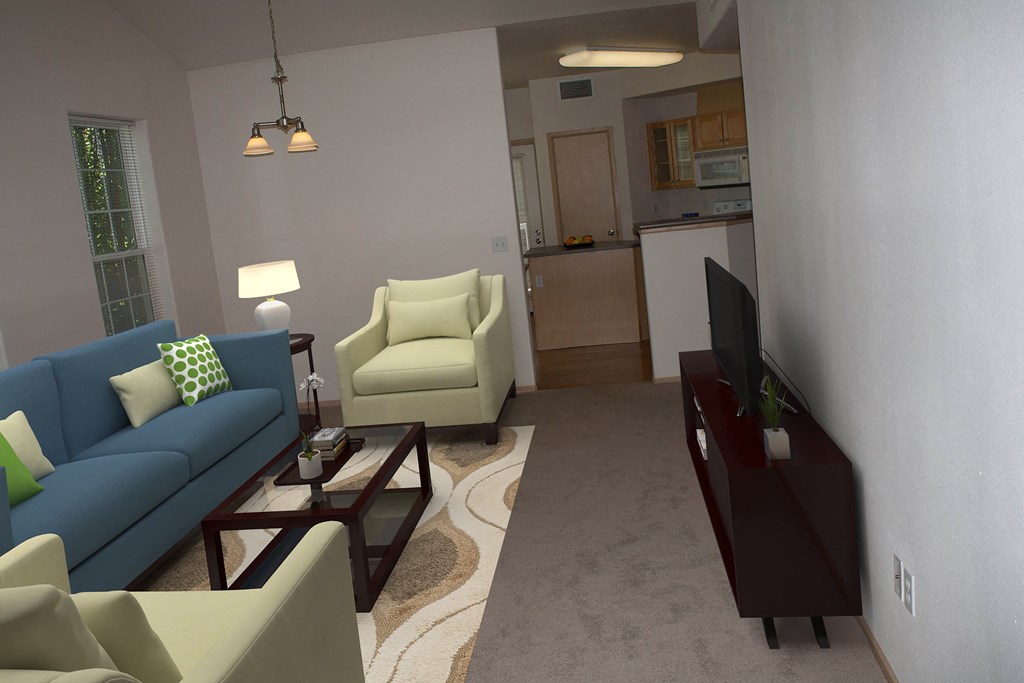 a living room with a blue couch and a coffee table.