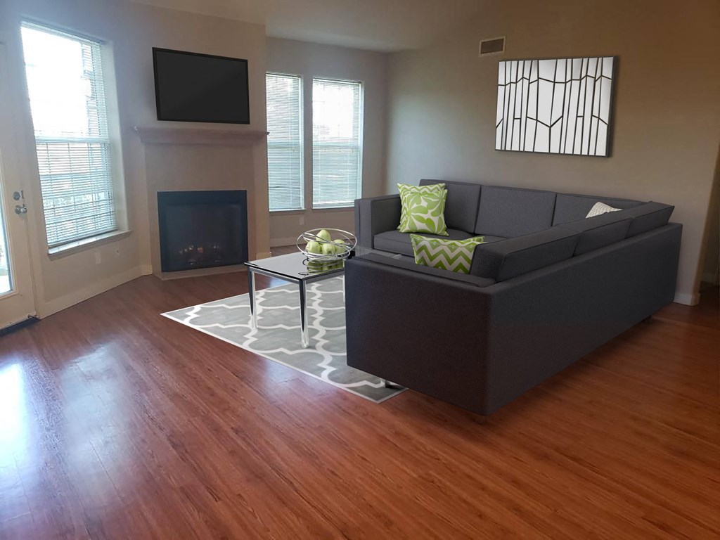 a living room with a couch and a coffee table in front of a fireplace.