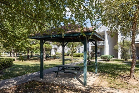a picnic pavilion with a picnic table in a park