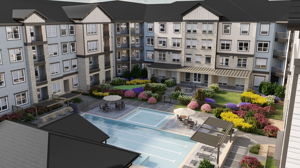 an aerial view of an apartment building with a pool and courtyard