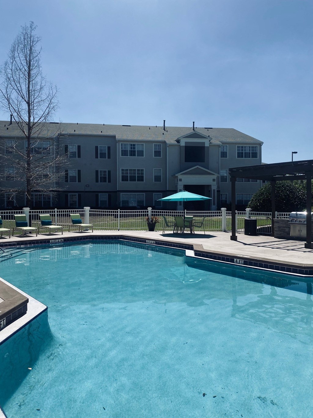 a large pool with a building in the background
