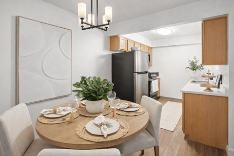 A modern dining room with a round table set for two.