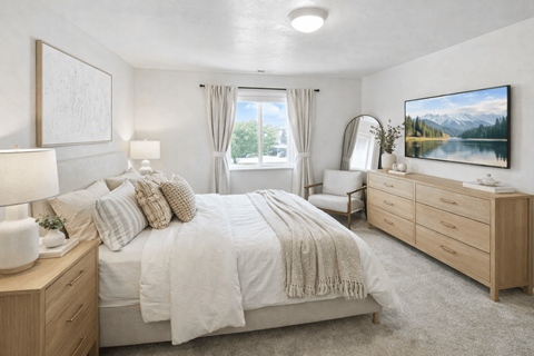 A bedroom with a large bed, a dresser, and a painting on the wall.