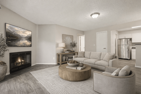 A modern living room with a fireplace and a painting on the wall.
