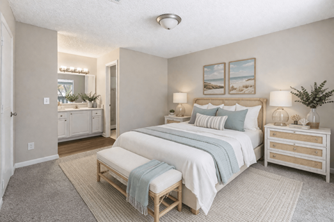 A bedroom with a large bed and a dresser. at Parkland at Orange Park Apartments , Orange Park, Florida