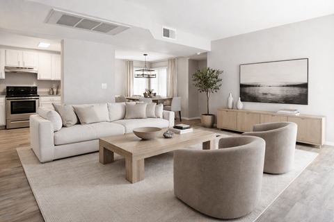 A modern living room with a white sofa, a wooden coffee table, and a large painting on the wall.