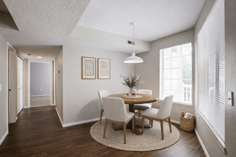 A dining room with a round table and chairs at Haven Pointe Apartments, West Haven, UT, 84401