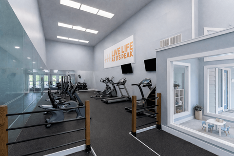 A gym with a variety of equipment and a sign at Parkland at Orange Park Apartments , Orange Park, FL, 32073