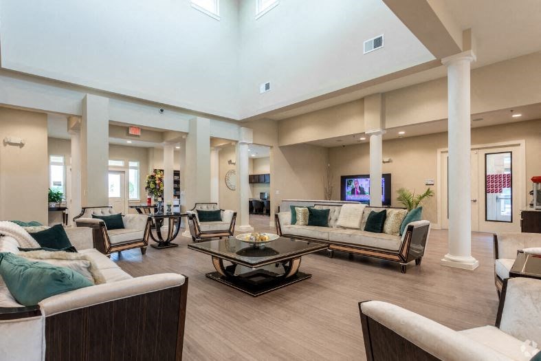 a large living room with couches and a table